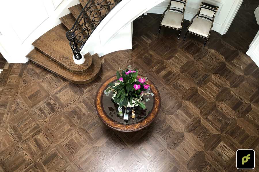 American Oak hand-made Monticello Paneled Parquetry with circumnavigating border designs. With a Stained Water-Based Polyurethane Finish. Satin in sheen.