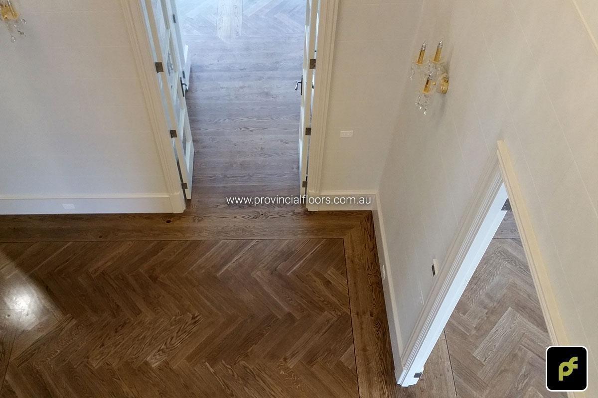 European Oak Herringbone Parquetry with a quadrant border design. With a Stained Water-Based Polyurethane Finish. Satin in sheen.