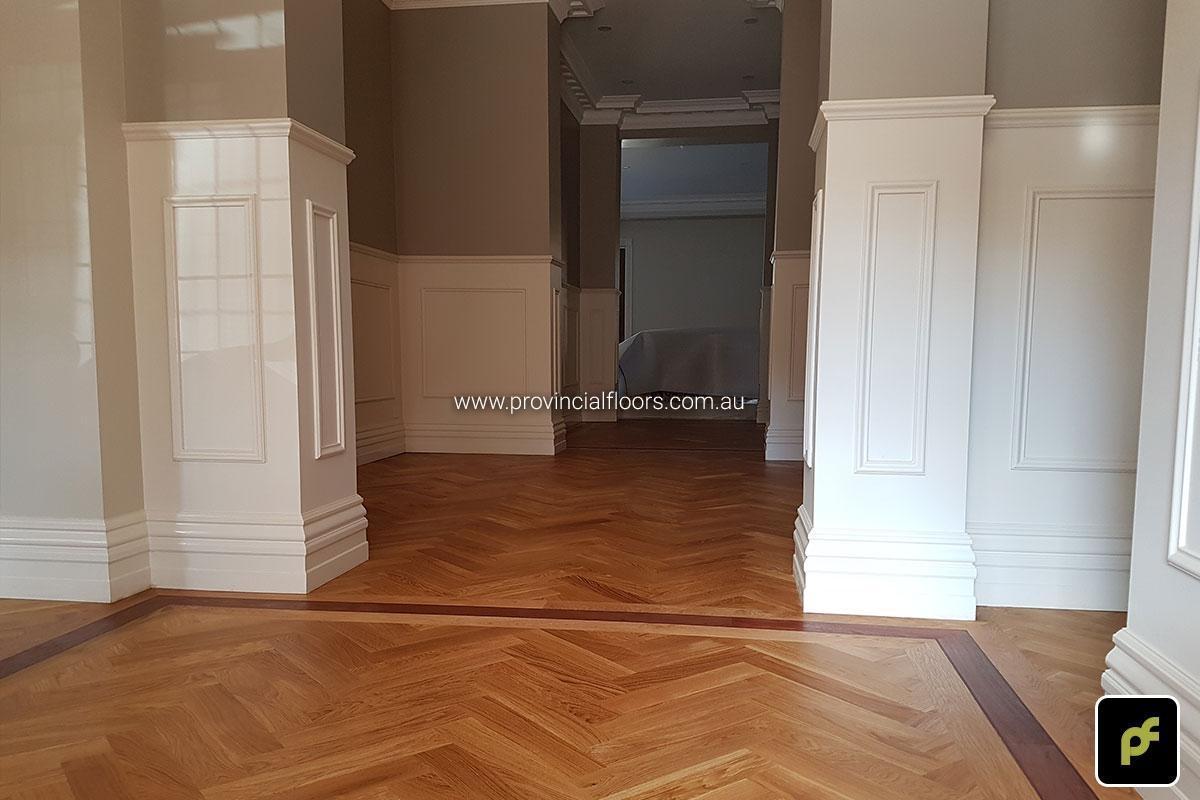 European Oak Herringbone Parquetry with a Jarrah border design feature. With a Natural Coloured Oil/Wax Finish. Matte in sheen and easily repairable.
