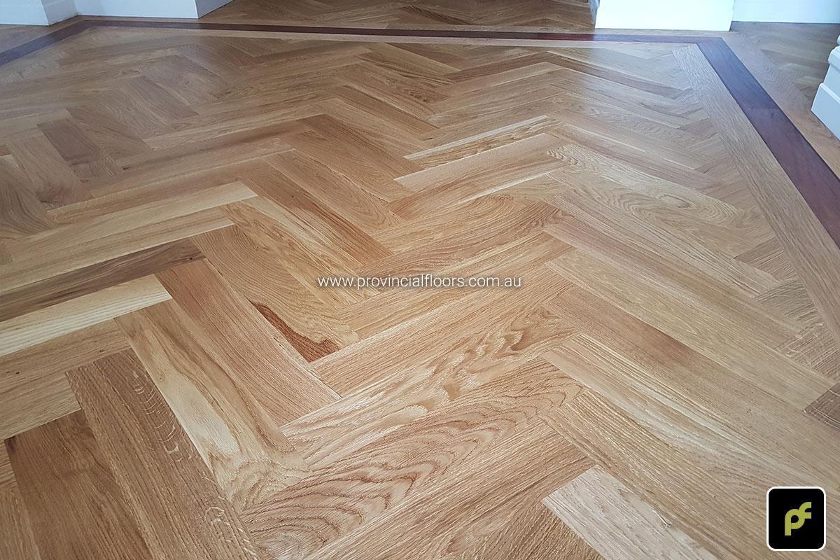 European Oak Herringbone Parquetry with a Jarrah border design feature. With a Natural Coloured Oil/Wax Finish. Matte in sheen and easily repairable.