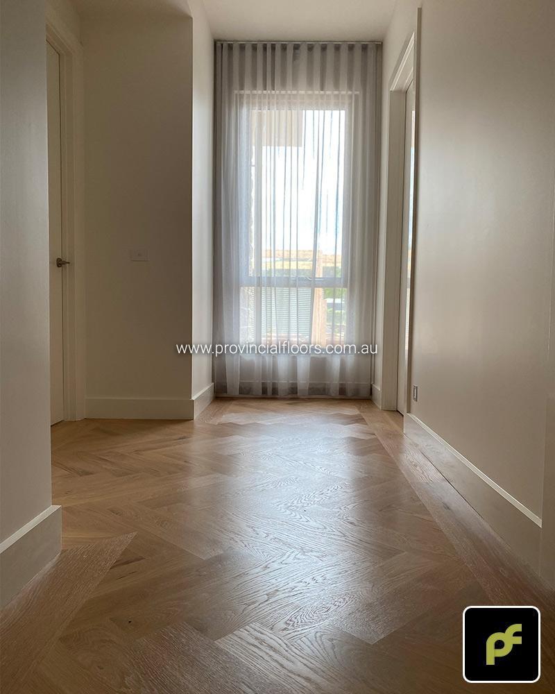 Solid American Oak Herringbone Parquetry with Custom Border Designs. With a Custom Coloured Oil/Wax Finish. Matte in sheen and easily repairable.
