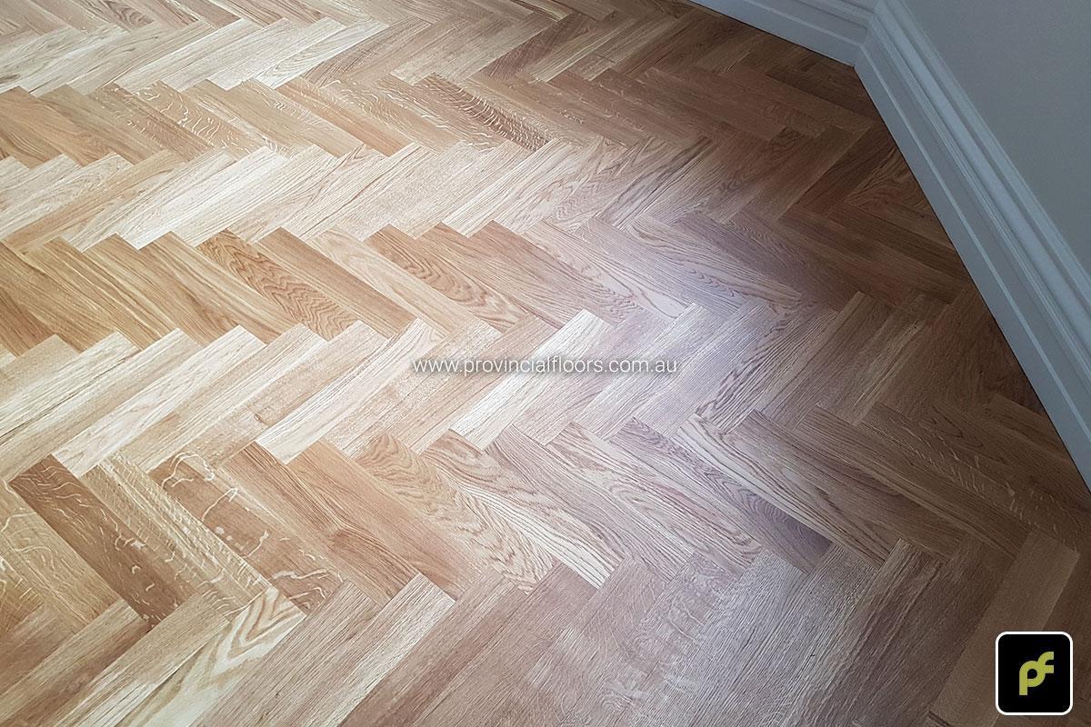 European Oak Herringbone Parquetry with a Jarrah border design feature. With a Natural Coloured Oil/Wax Finish. Matte in sheen and easily repairable.
