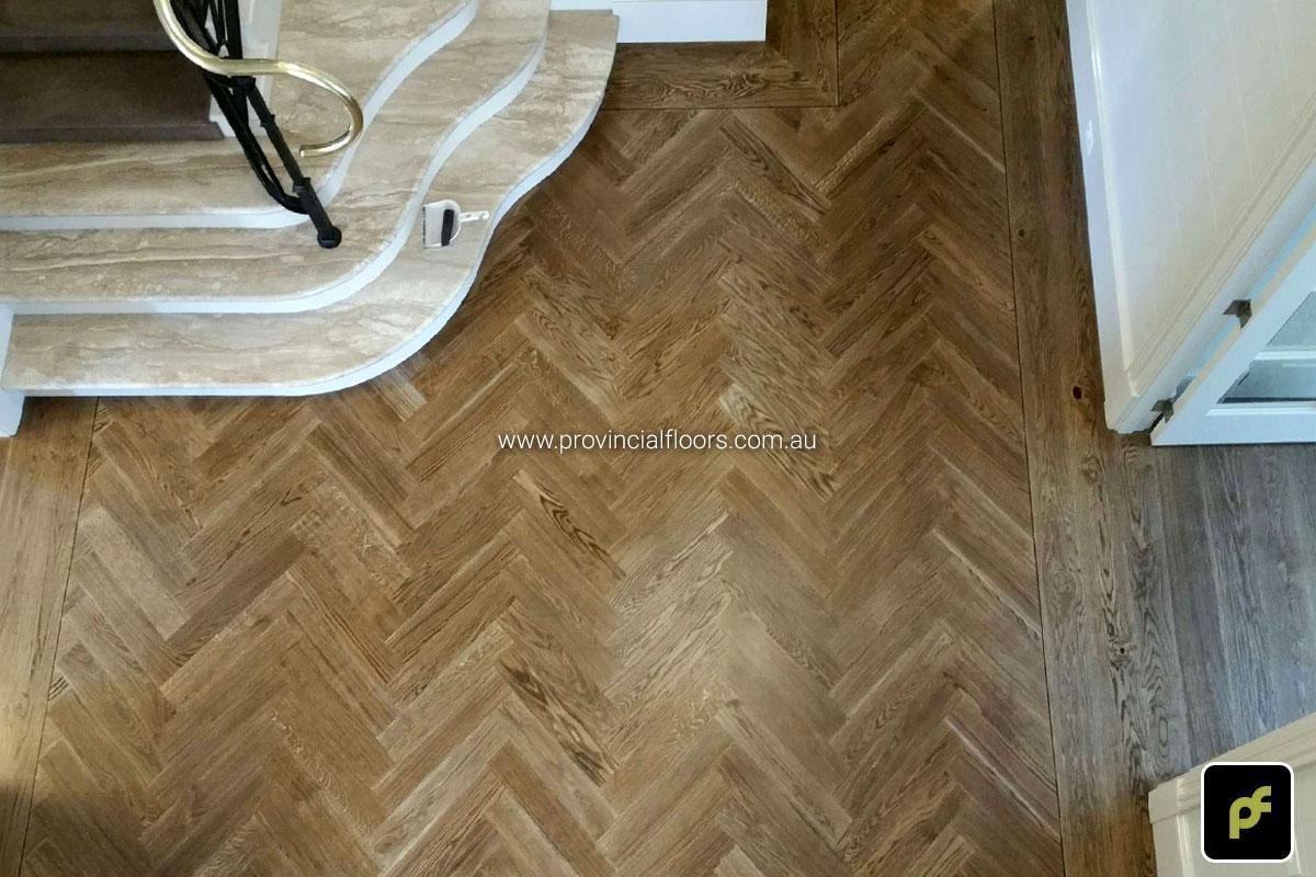 European Oak Herringbone Parquetry with a quadrant border design. With a Stained Water-Based Polyurethane Finish. Satin in sheen.