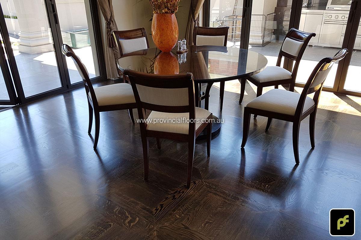 American Oak hand-made Monticello Paneled Parquetry with circumnavigating border designs. With a Stained Water-Based Polyurethane Finish. Satin in sheen.