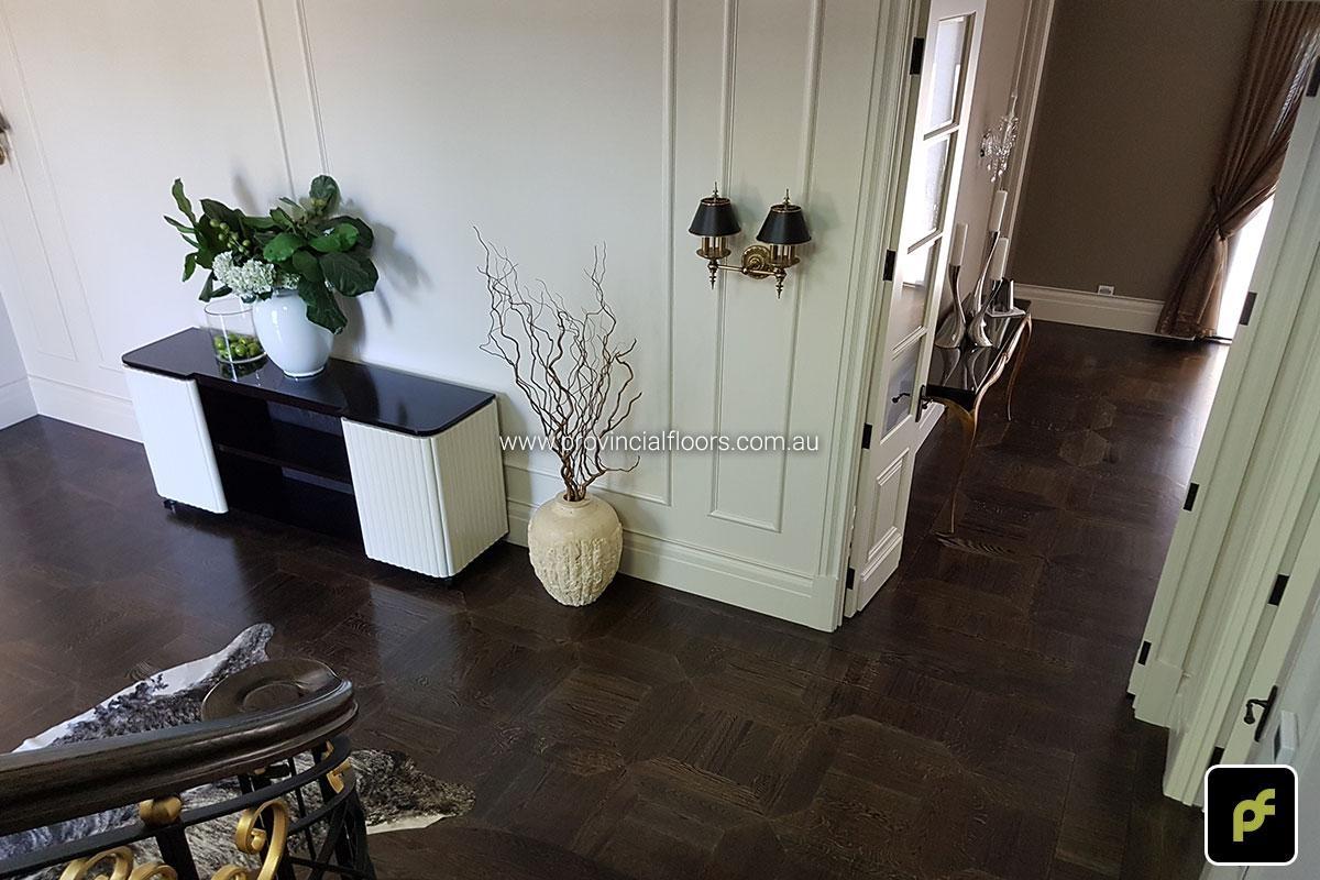 American Oak hand-made Monticello Paneled Parquetry with circumnavigating border designs. With a Stained Water-Based Polyurethane Finish. Satin in sheen.