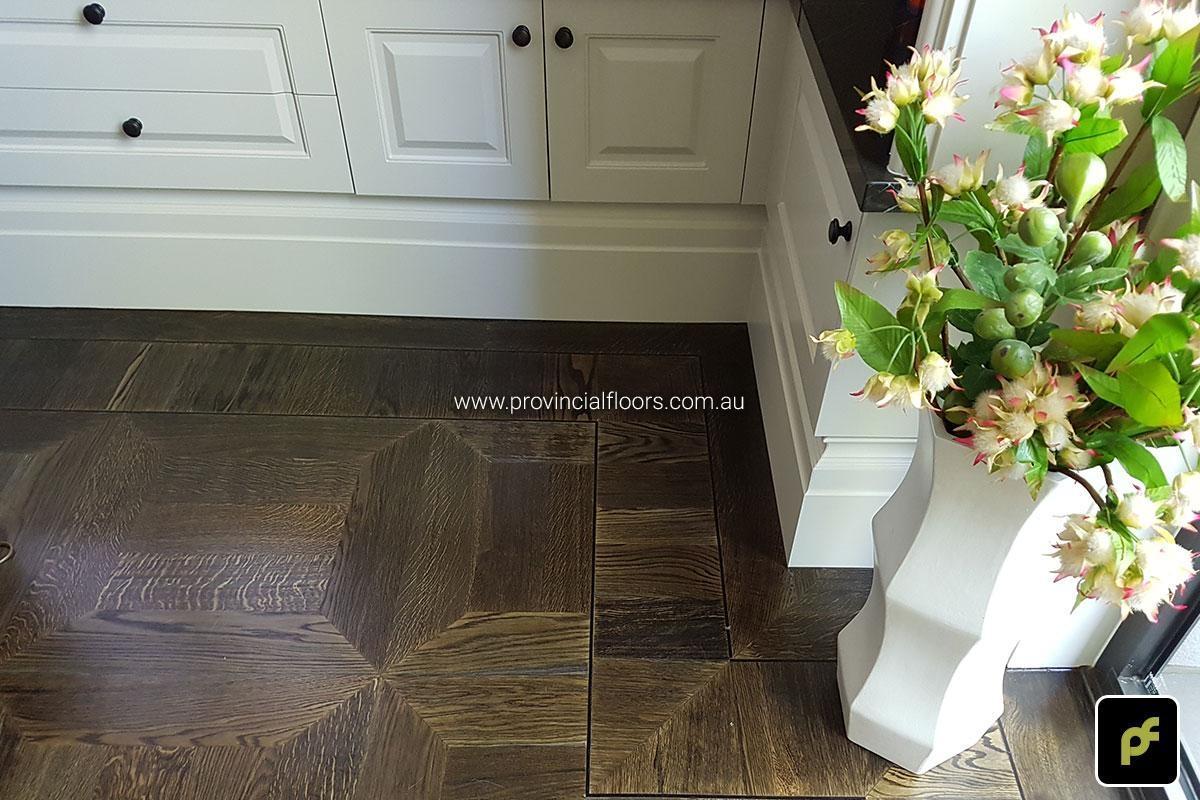 American Oak hand-made Monticello Paneled Parquetry with circumnavigating border designs. With a Stained Water-Based Polyurethane Finish. Satin in sheen.