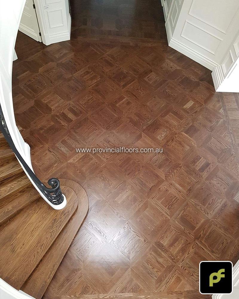 American Oak hand-made Monticello Paneled Parquetry with circumnavigating border designs. With a Stained Water-Based Polyurethane Finish. Satin in sheen.