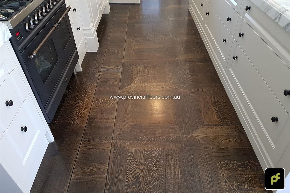 American Oak hand-made Monticello Paneled Parquetry with circumnavigating border designs. With a Stained Water-Based Polyurethane Finish. Satin in sheen.