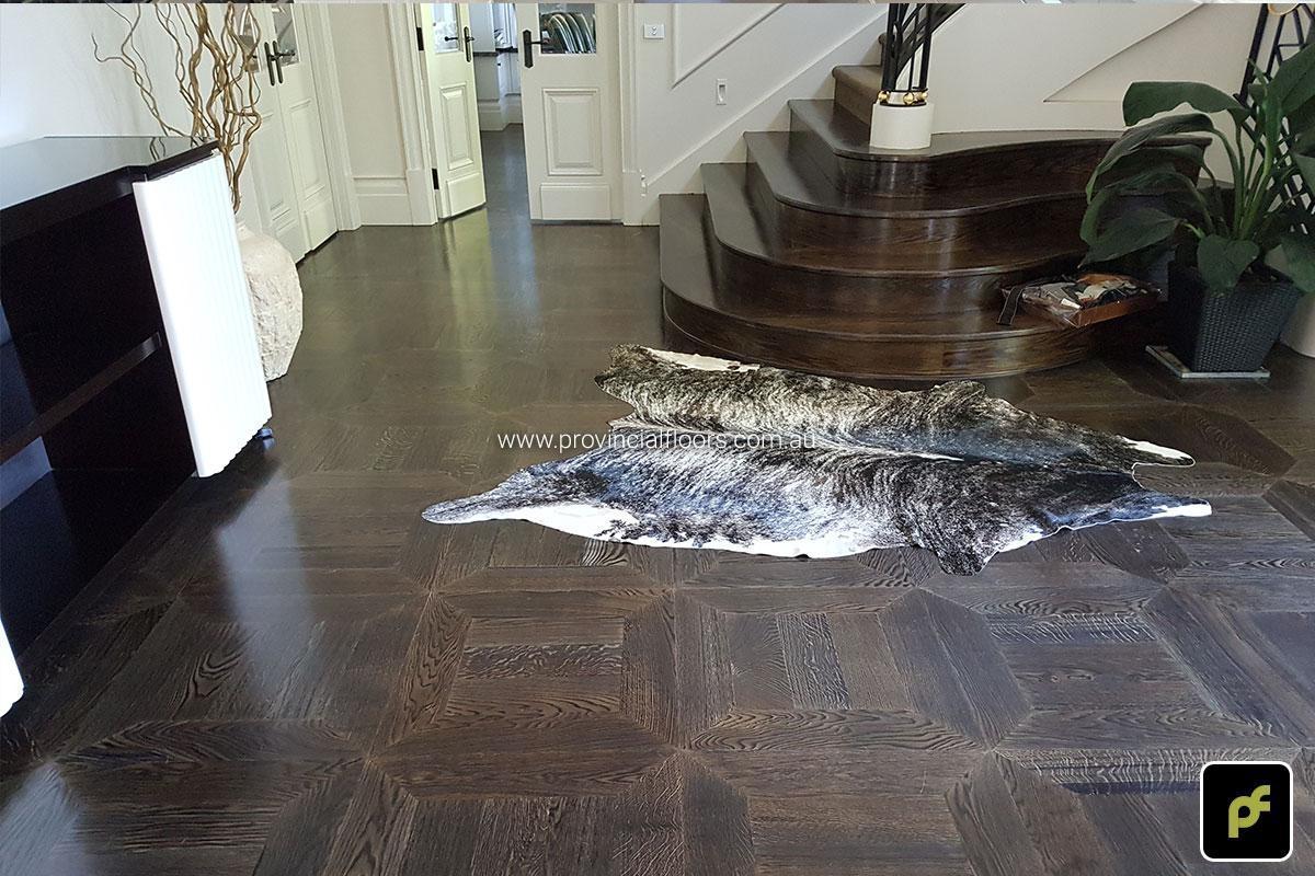 American Oak hand-made Monticello Paneled Parquetry with circumnavigating border designs. With a Stained Water-Based Polyurethane Finish. Satin in sheen.
