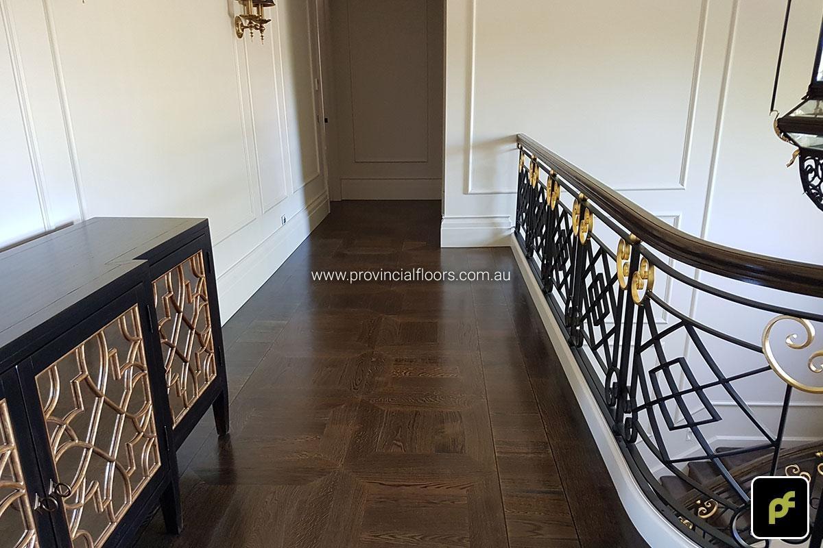 American Oak hand-made Monticello Paneled Parquetry with circumnavigating border designs. With a Stained Water-Based Polyurethane Finish. Satin in sheen.