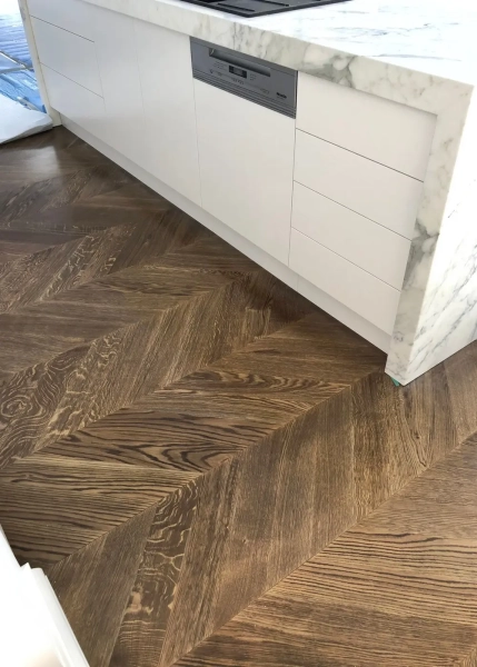 European Oak Chevron Parquetry Flooring with a Stained Waterbased Coating Finish. Satin in sheen - Kitchen Close Up