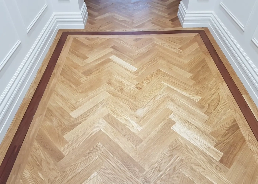European Oak Herringbone Parquetry Flooring with a Jarrah border design feature. With a Natural Coloured Oil/Wax Finish. Matte in sheen - Border