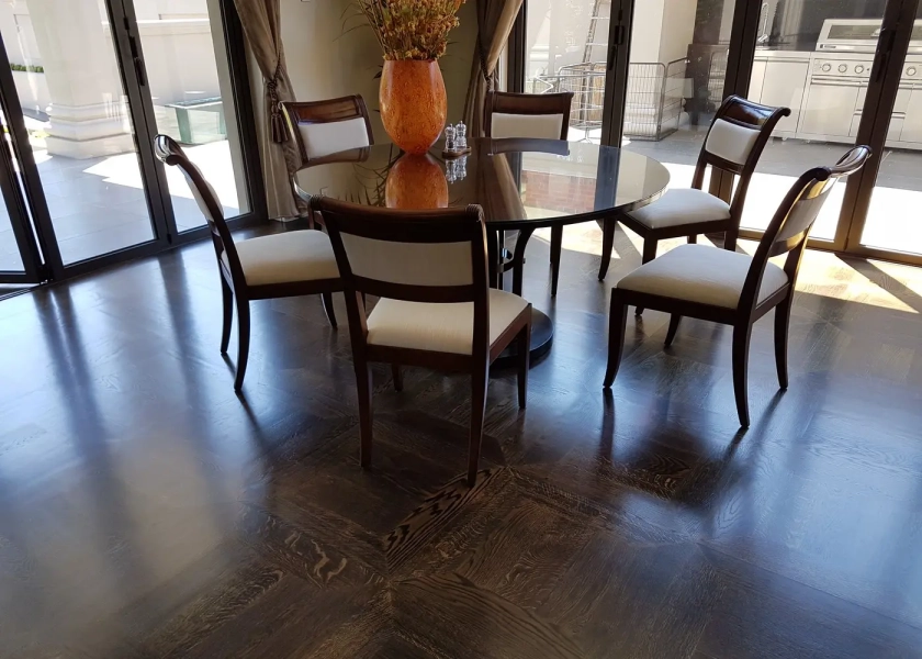 American Oak hand-made Monticello Flooring with circumnavigating border designs. With a Stained Waterbased Coating. Satin in sheen - Secondary Dining