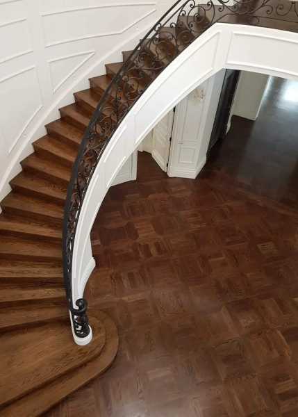 American Oak hand-made Monticello Flooring with circumnavigating border designs. With a Stained Waterbased Coating. Satin in sheen - Birds Eye with Staircase