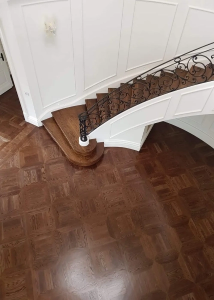 American Oak hand-made Monticello Parquetry Flooring with circumnavigating border designs. With a Stained Waterbased Coating. Satin in sheen - Birds Eye Entrance with Stairs