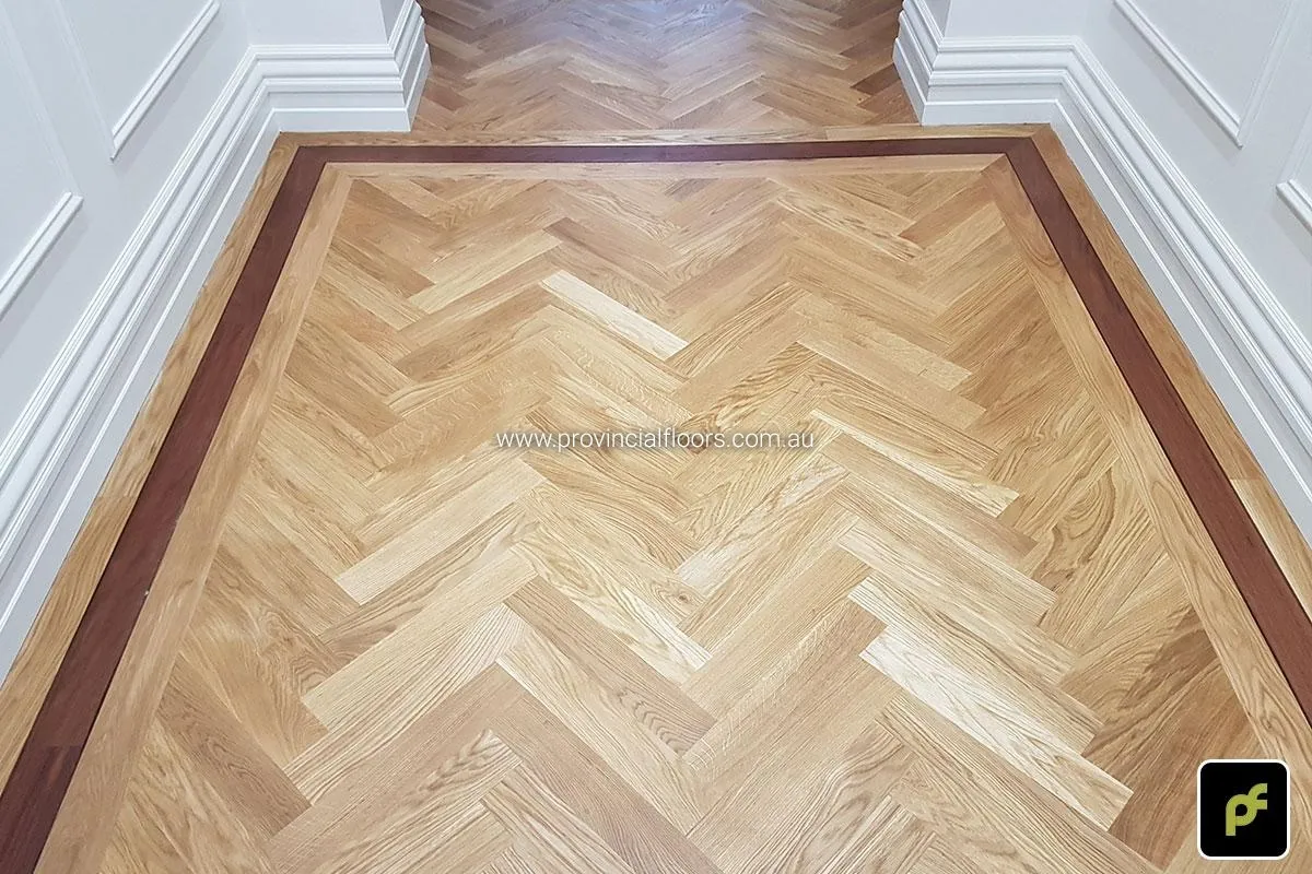 European Oak Herringbone Parquetry with a Jarrah border design feature. With a Natural Coloured Oil/Wax Finish. Matte in sheen and easily repairable.