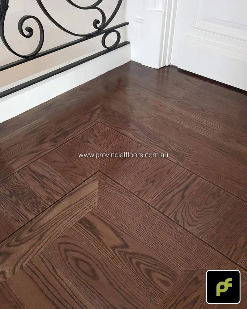 American Oak hand-made Monticello Paneled Parquetry with circumnavigating border designs. With a Stained Water-Based Polyurethane Finish. Satin in sheen.